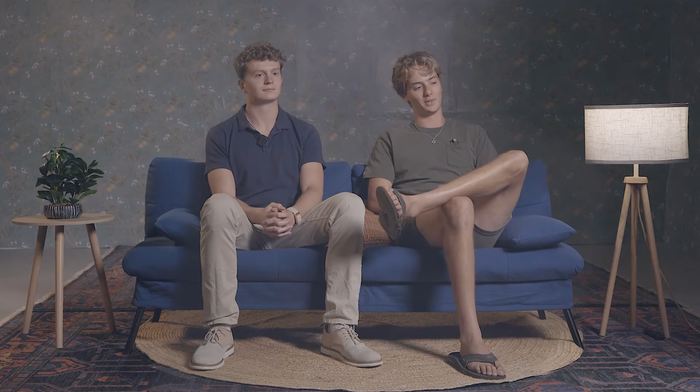 Two Palantir employees sitting for an interview on a couch