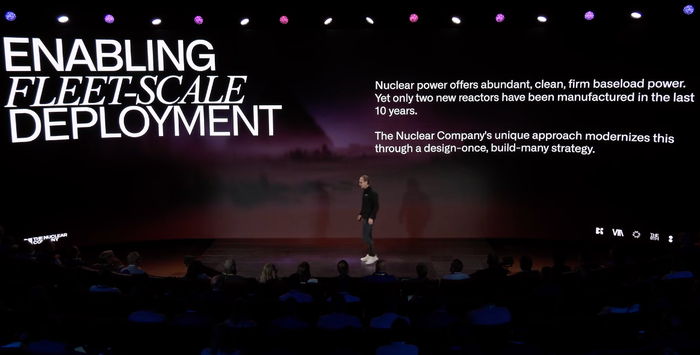 A presenter speaking on stage at Palantir's AIPCon.