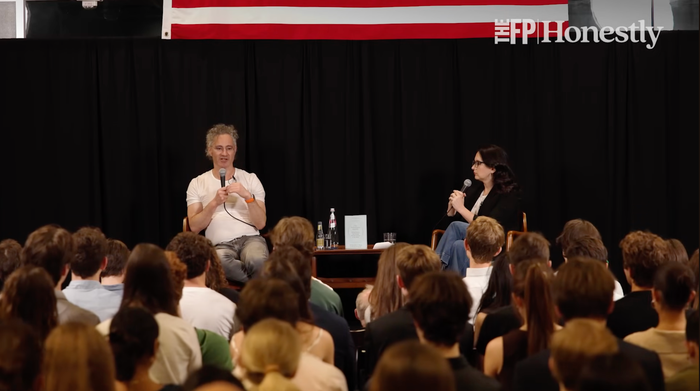 Alex Karp on stage speaking to an audience of college students.