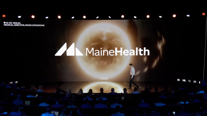 A presenter speaking on stage at Palantir's AIPCon.